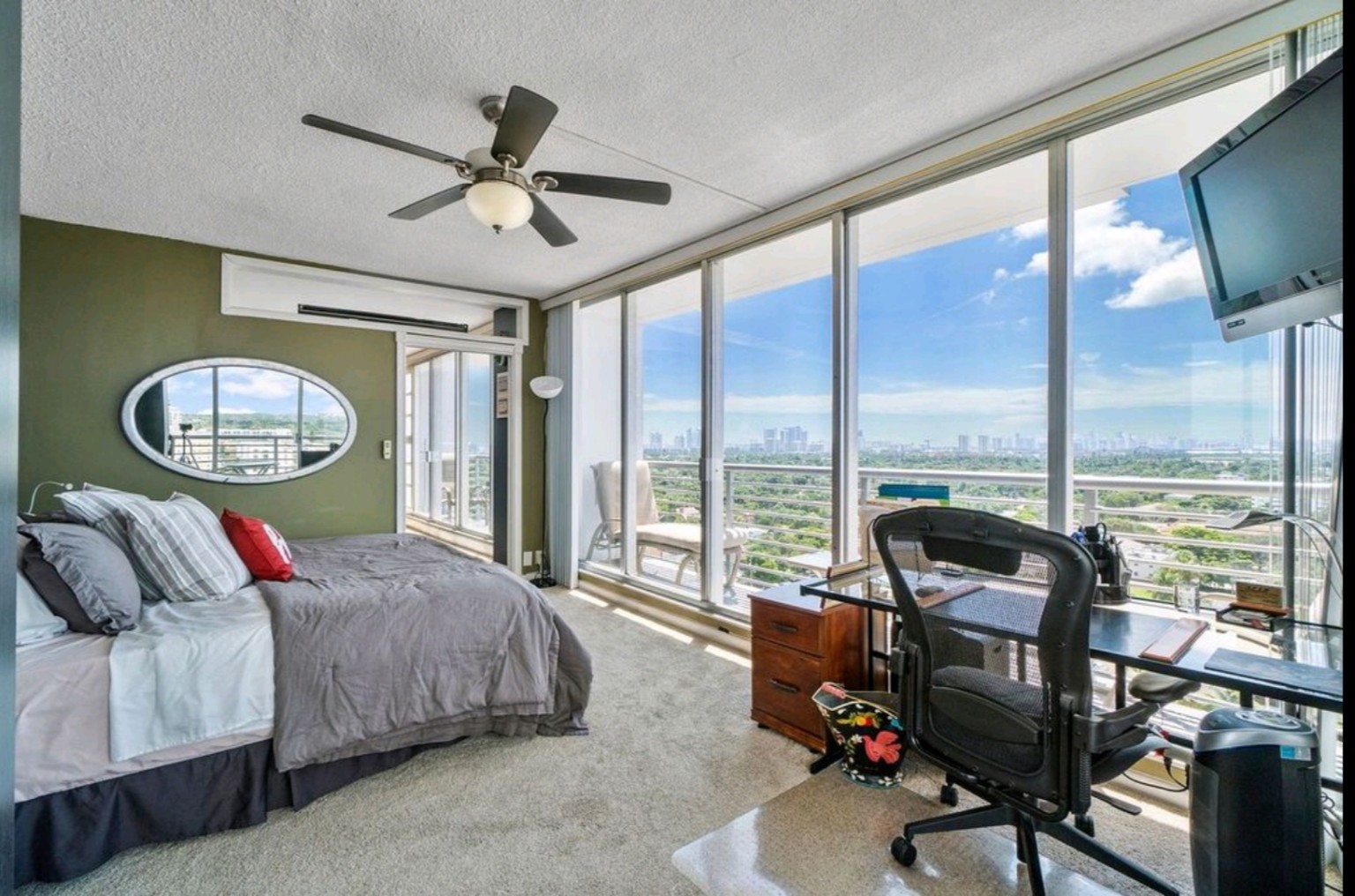 King bedroom with glass-desk workspace, floor-to-ceiling windows and skyline views