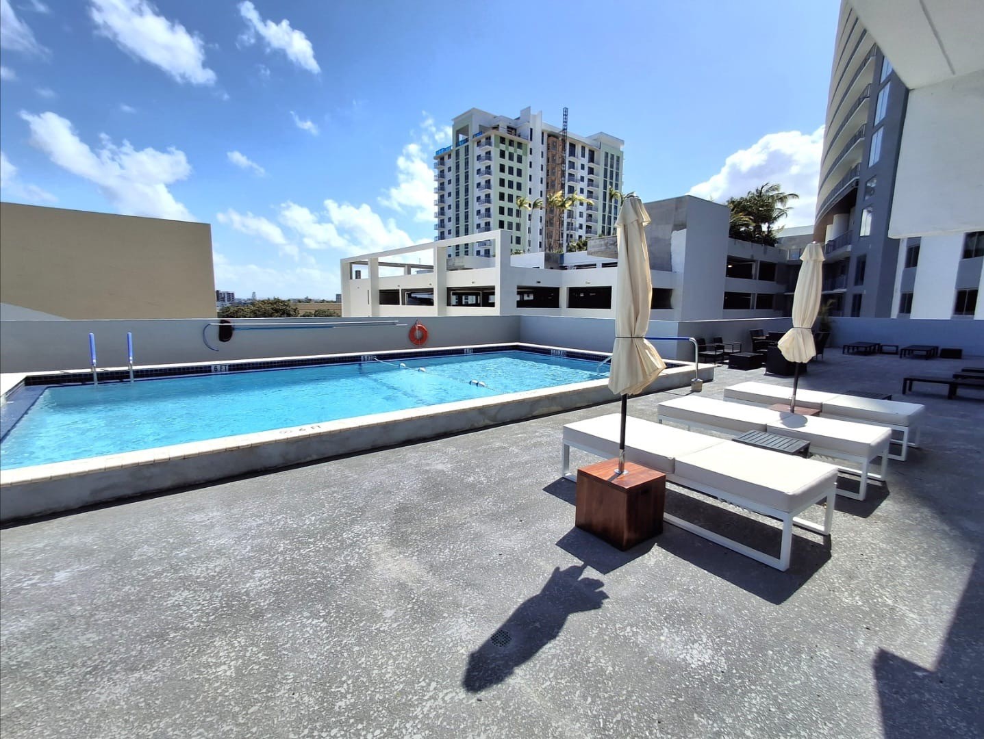 Outdoor swimming pool and furnished lounge deck at the building