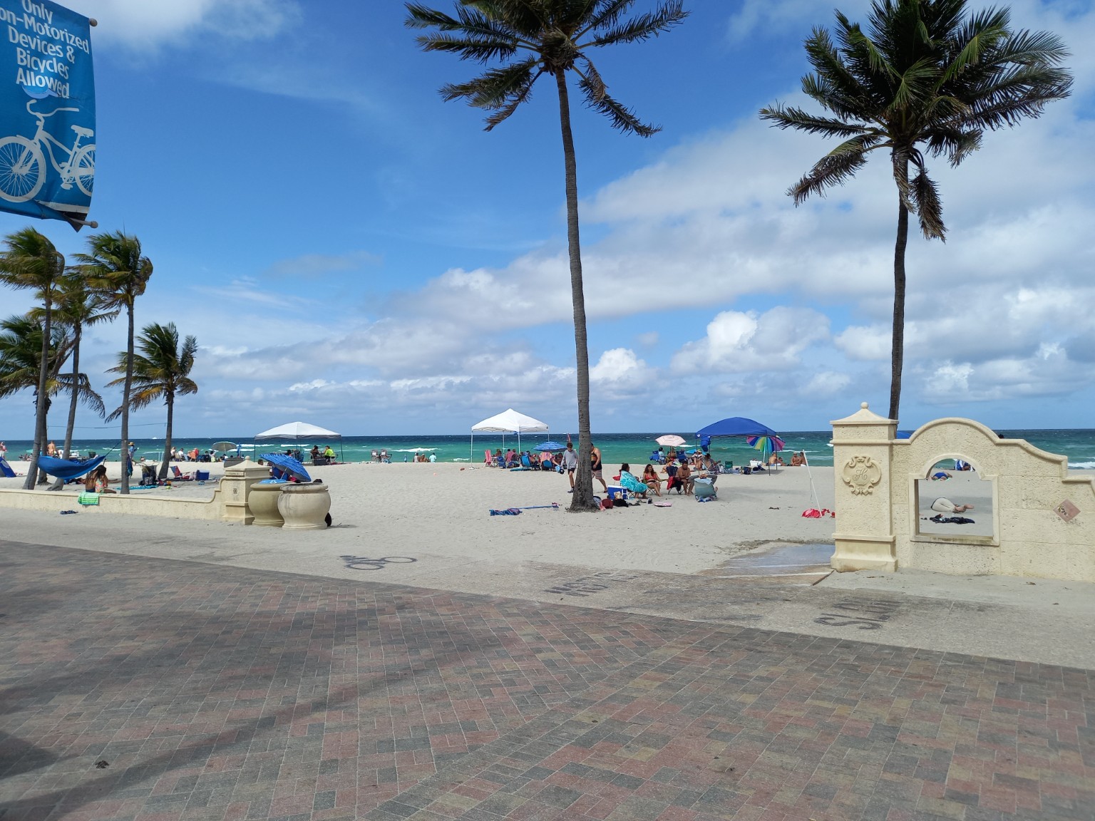 Hollywood Beach Broadwalk, palm trees and Atlantic Ocean on a clear day