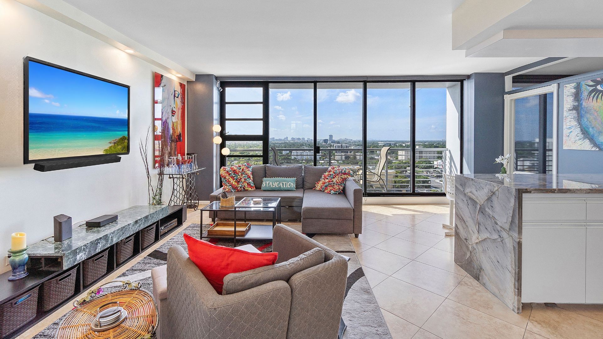 Bright living room with floor-to-ceiling windows and skyline views